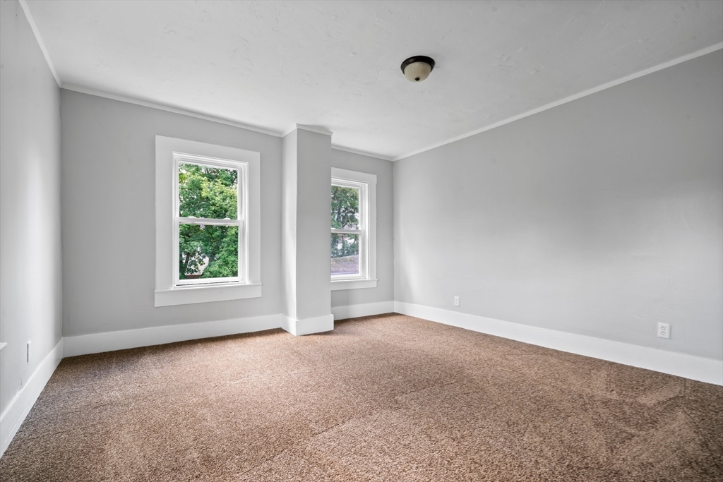 64 Pleasant Street Ware, MA 01082 - Photo 30 of 38 an empty room with windows and closet