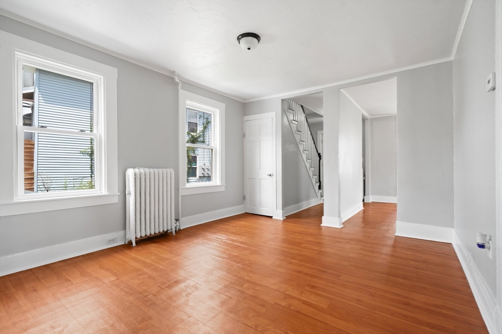 64 Pleasant Street Ware, MA 01082 - Photo 7 of 38 a view of an empty room with wooden floor and a window