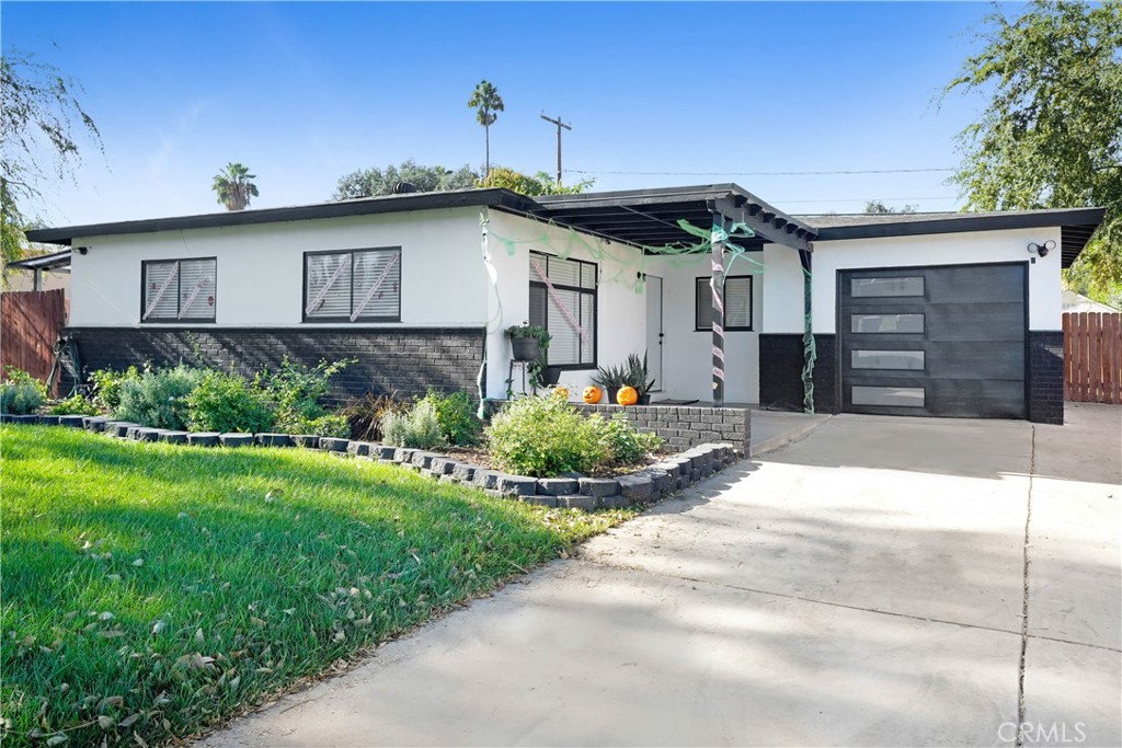 3160 Jane Street Riverside, CA 92506 - Photo 1 of 1 a front view of a house with a yard and garage