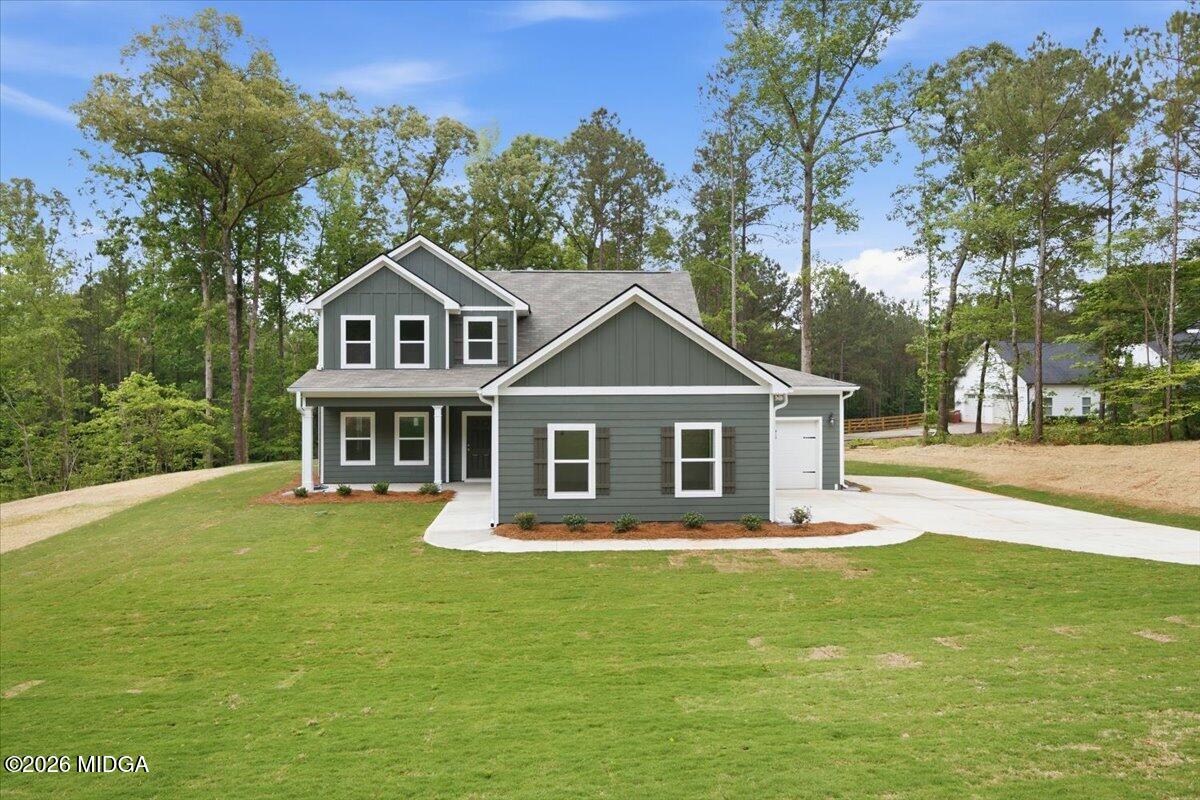 2762 Boxankle Road Forsyth, GA 31029 - Photo 1 of 19 a front view of a house with a garden and trees