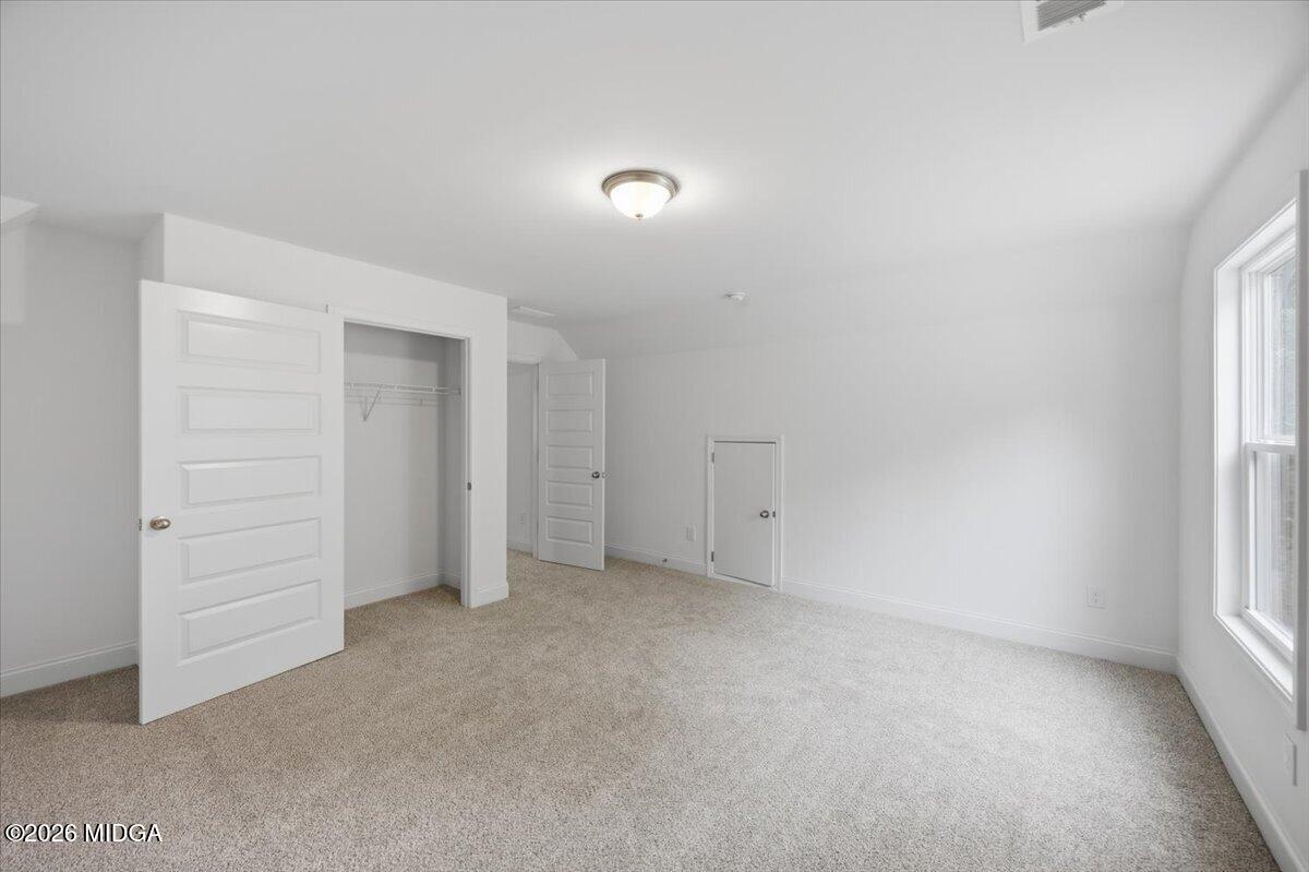 2762 Boxankle Road Forsyth, GA 31029 - Photo 14 of 19 an empty room with closet and natural light