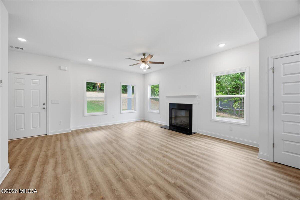 2762 Boxankle Road Forsyth, GA 31029 - Photo 3 of 19 an empty room with windows and a fireplace