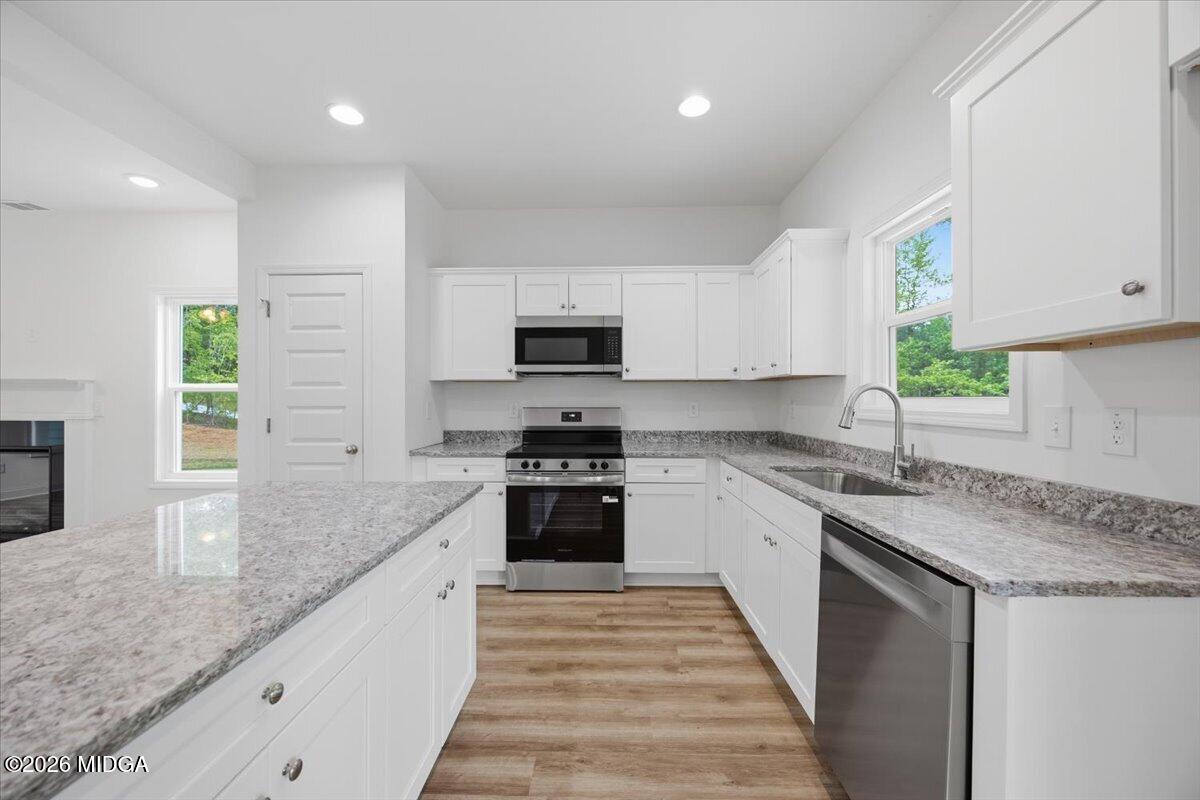 2762 Boxankle Road Forsyth, GA 31029 - Photo 4 of 19 a kitchen with stainless steel appliances granite countertop a sink a stove top oven a counter space and cabinets