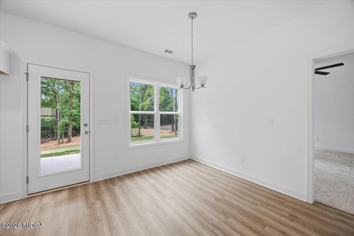 2762 Boxankle Road Forsyth, GA 31029 - Photo 6 of 19 a view of an empty room with wooden floor and a window
