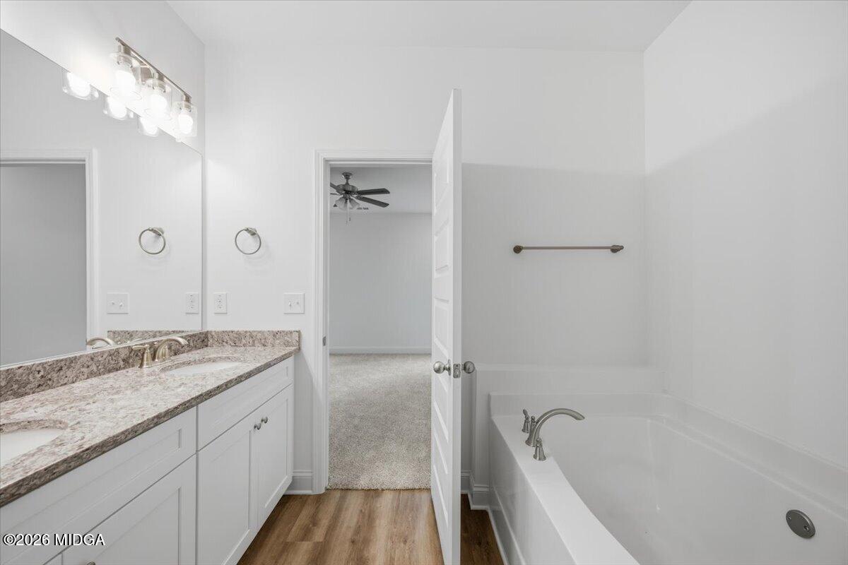 2762 Boxankle Road Forsyth, GA 31029 - Photo 10 of 19 a bathroom with a granite countertop sink a mirror and a bathtub