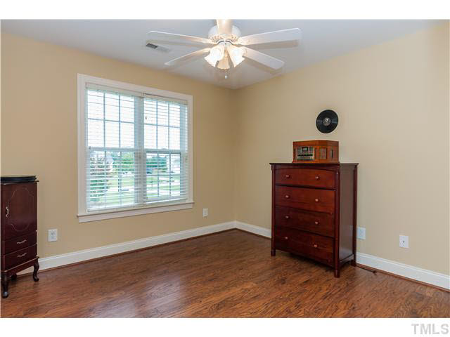 5820 Turner Store Lane Raleigh, NC 27603 - Photo 16 of 25 Third bedroom includes hardwoods, double window with wood blinds, ceiling fan and double closet.