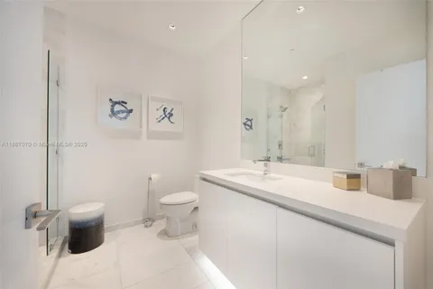 a room with a chair and a chandelier