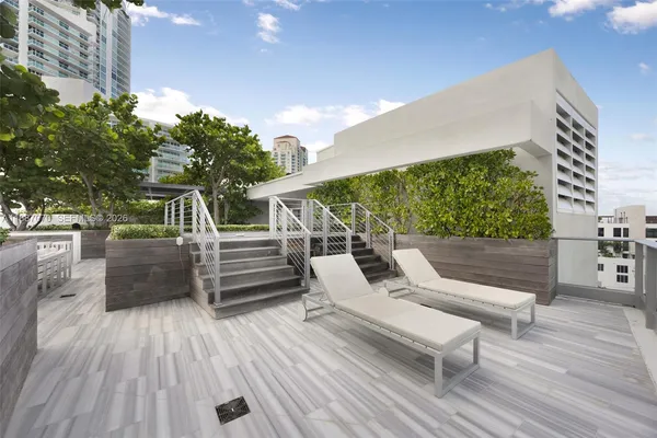 a view of a patio with table and chairs and wooden floor
