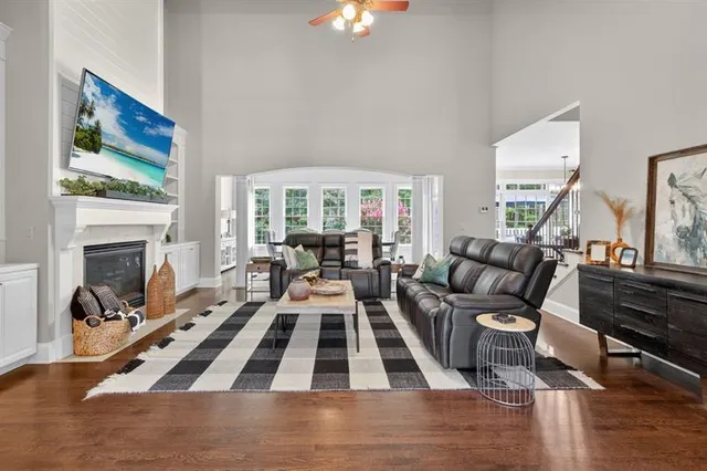 a kitchen with kitchen island granite countertop a sink cabinets and wooden floor