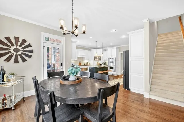 a view of a room with wooden floor furniture and windows