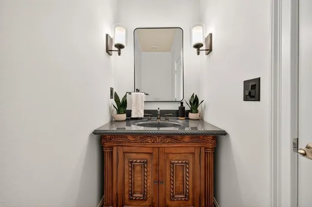 a bathroom with a double vanity sink mirror and toilet