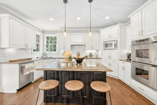 a bedroom with a bed table and a potted plant