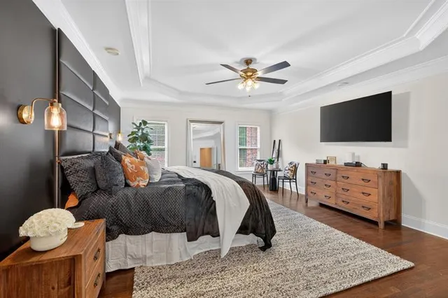 a front view of a house with a yard and trees