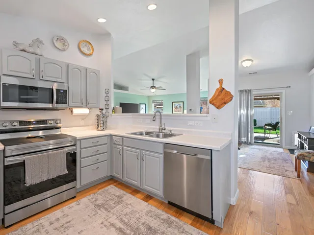 a kitchen with stainless steel appliances granite countertop a stove and a sink