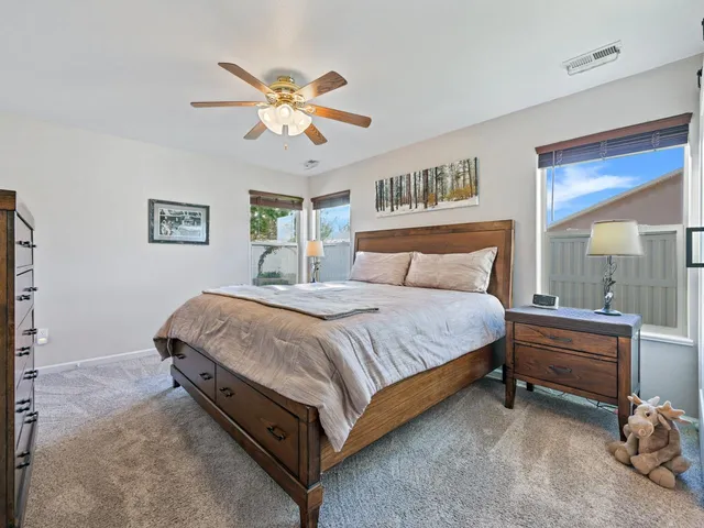 a bedroom with a bed and a chandelier