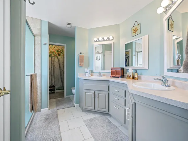a spacious bathroom with a double vanity sink mirror and double
