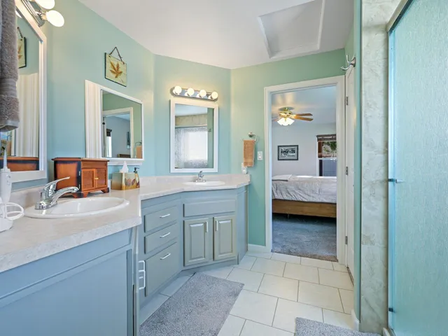 a en suite bathroom with a tub sink and mirror