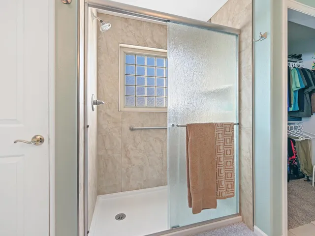 a bathroom with a glass shower door