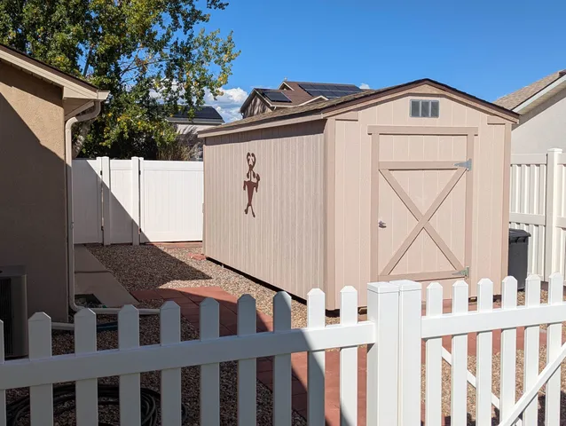 a view of a garden with a building in the background