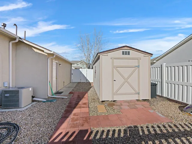 a view of a house with a yard and a tree