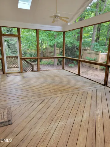 a view of a room with wooden floor and windows