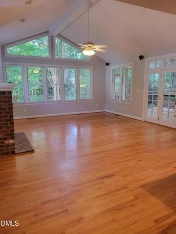 a view of room with window and wooden floor