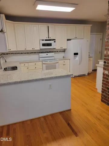 a kitchen with stainless steel appliances a refrigerator sink and cabinets