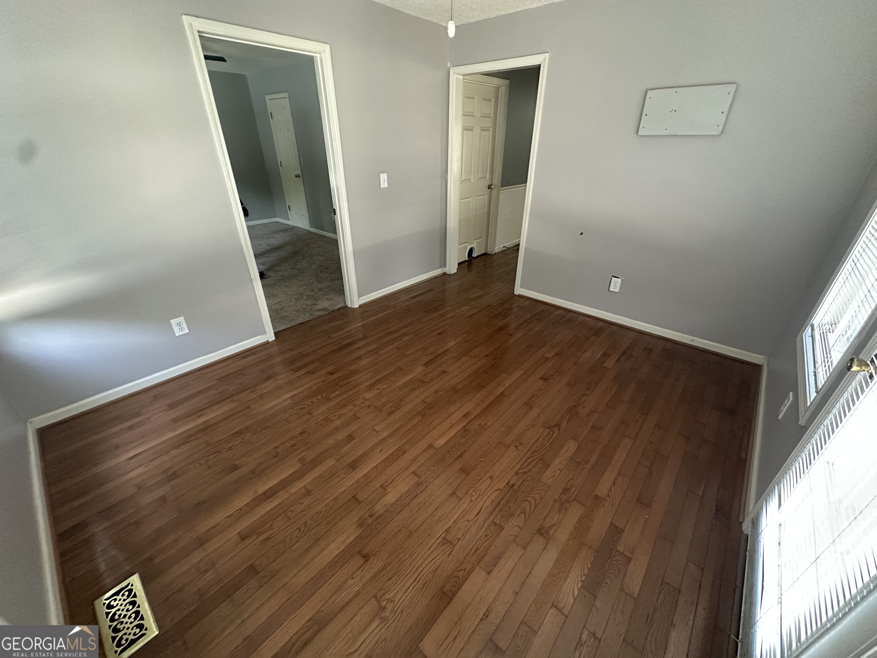 384 Sam Brown Boulevard Commerce, GA 30529 - Photo 16 of 25 wooden floor in an empty room with a window