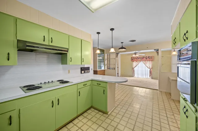 a kitchen with a sink a stove and cabinets
