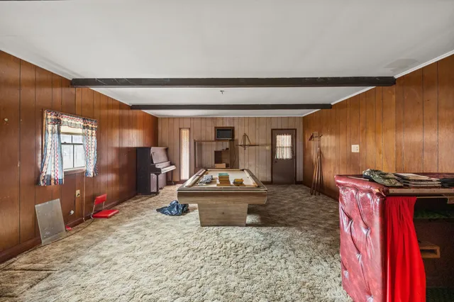 a living room with furniture gym equipment and a large window