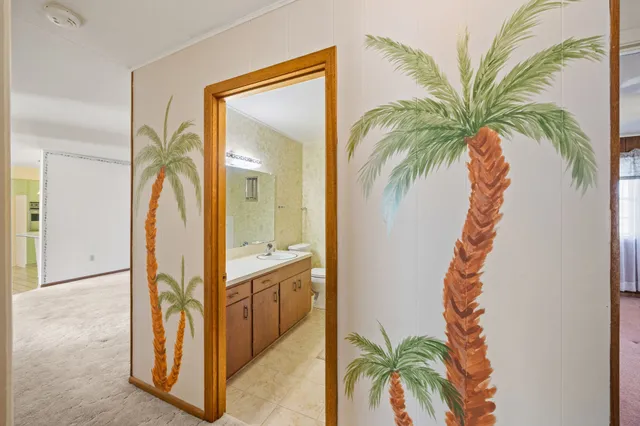 a view of a hallway with paintings on the wall