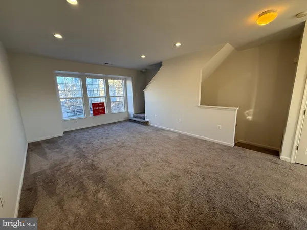 a kitchen with kitchen island a sink stove and refrigerator