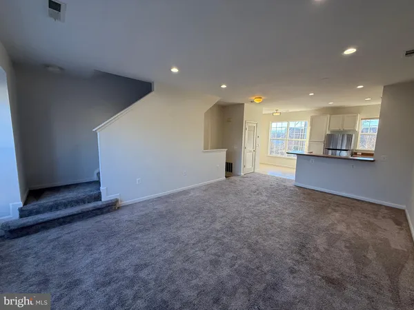 a kitchen with kitchen island a counter top space stainless steel appliances and a window