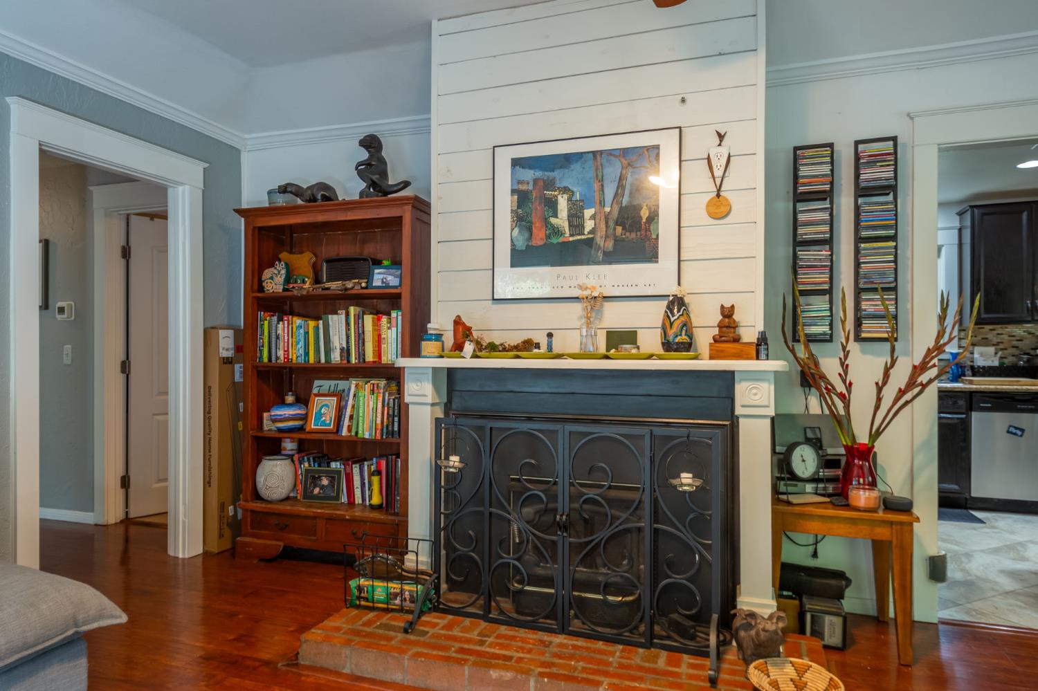 15663 Ojai Road Santa Paula, CA 93060 - Photo 7 of 47 a dining room with wooden floor and a book shelf