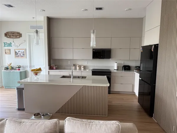 a kitchen with a sink cabinets and appliances