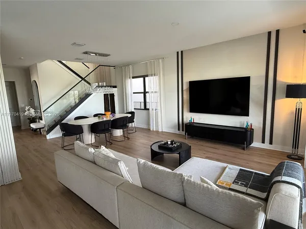 a living room with furniture and a flat screen tv