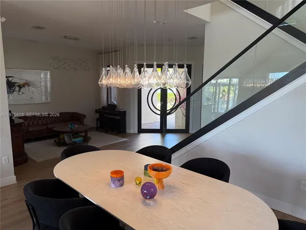 a living room with furniture and chandelier