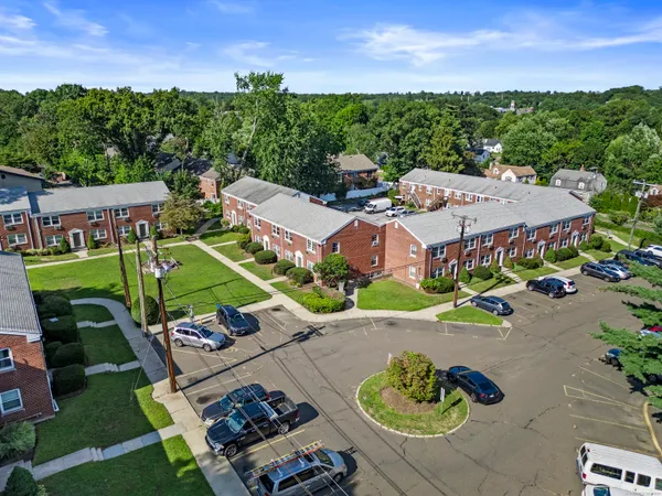 an aerial view of a house with garden space and street view