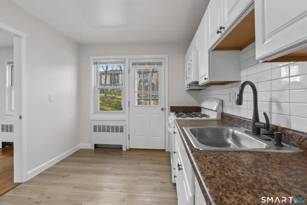 a kitchen with a sink stove and cabinets