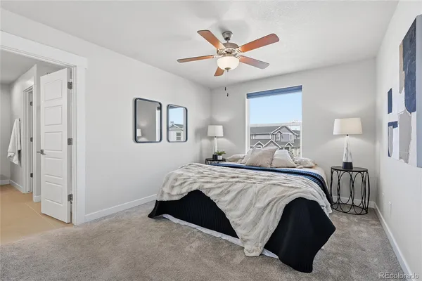 a spacious bedroom with a bed and a chandelier