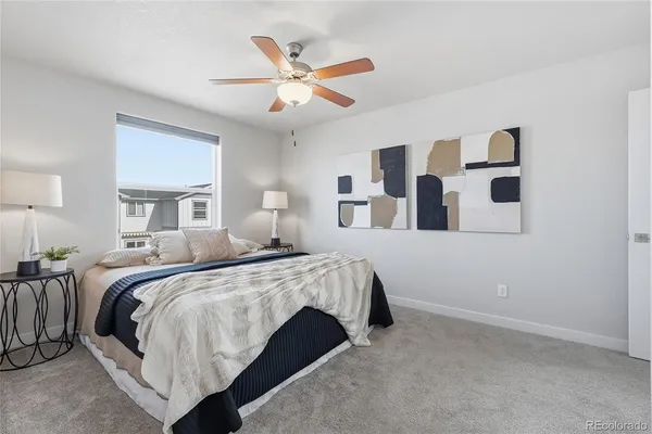 a bedroom with a bed and a painting on the wall