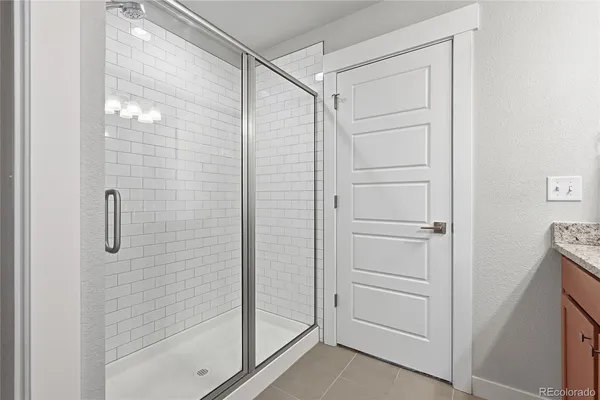 a bathroom with a glass shower door