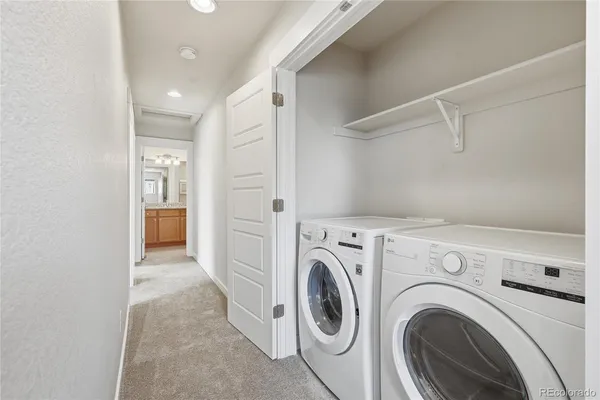 a view of a hallway with washer and dryer
