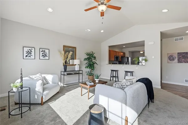 a living room with furniture and wooden floor