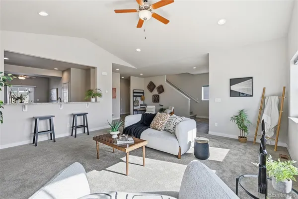 a living room with furniture and a chandelier
