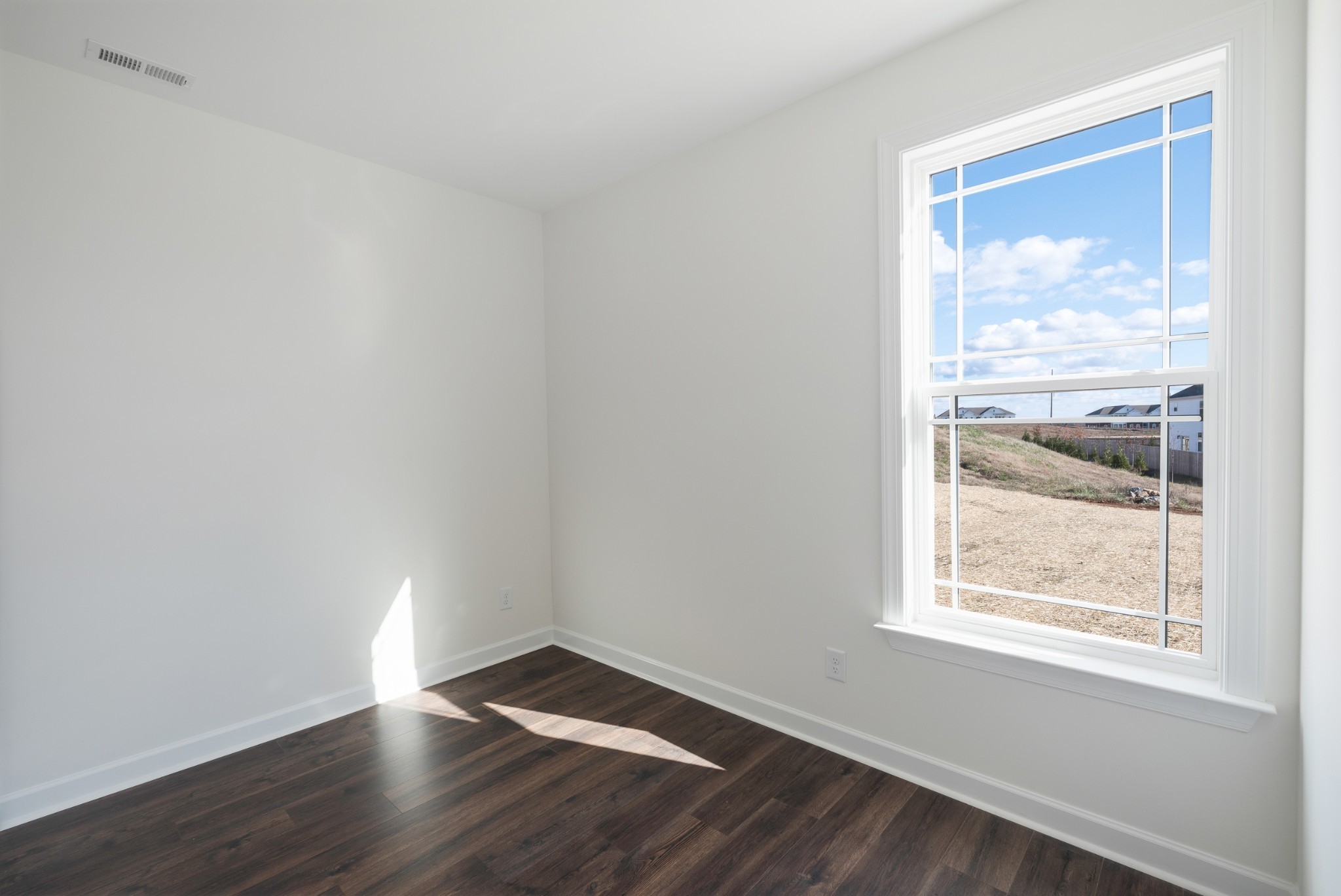 4010 Rampart Way Spring Hill Spring Hill, TN 37174 - Photo 12 of 34 a view of an empty room with wooden floor and a window