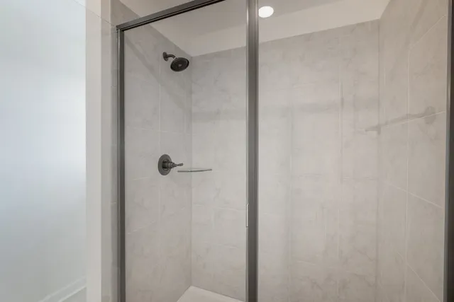 a bathroom with a glass shower door