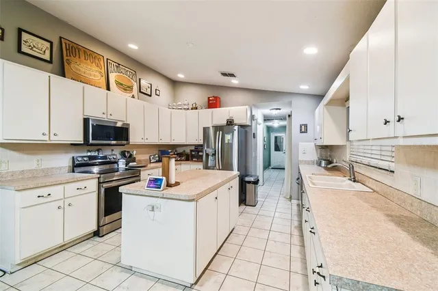 a living room with furniture a flat screen tv and a large window