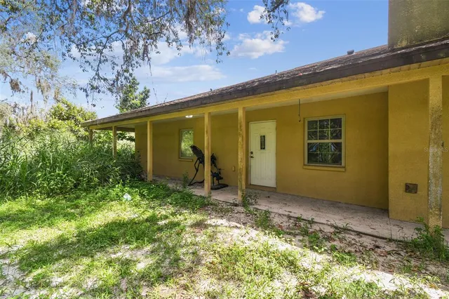 a view of a lush green field with a building in the background