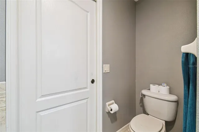 a bathroom with a sink a toilet and shower curtain